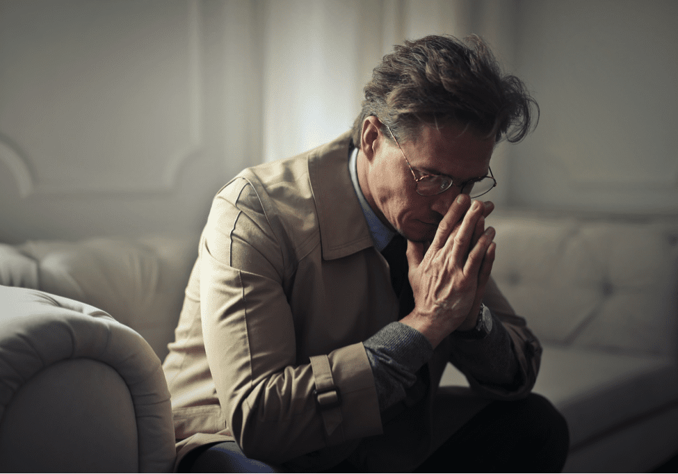 man leaning his head